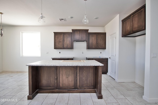 15341 Idea Ln, El Paso, TX 79938 - kitchen featuring a center island, dark brown cabinets, and decorative light fixtures