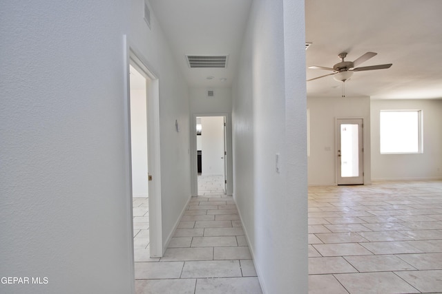 15341 Idea Ln, El Paso, TX 79938 - hallway featuring light tile patterned flooring, a textured wall, and baseboards