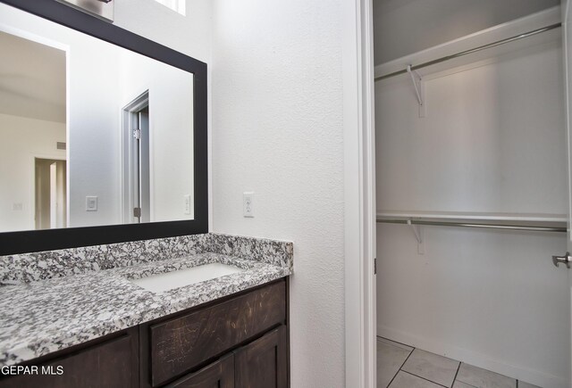 15341 Idea Ln, El Paso, TX 79938 - bathroom featuring vanity, a walk in closet, and tile patterned flooring