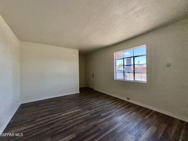 5017 Sierra Madre Dr, El Paso, TX 79904 - unfurnished room with dark wood-style floors, baseboards, and a textured ceiling