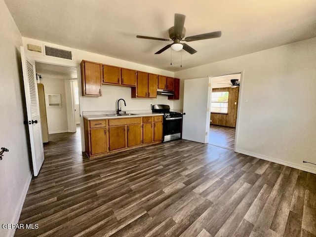 5017 Sierra Madre Dr, El Paso, TX 79904 - kitchen featuring range with gas stovetop, a sink, ceiling fan, light countertops, and dark wood-style floors