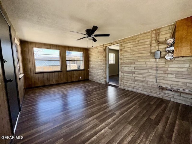 5017 Sierra Madre Dr, El Paso, TX 79904 - unfurnished room with wood finished floors, healthy amount of natural light, ceiling fan, a textured ceiling, and wood walls