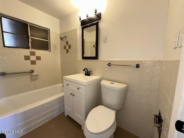 5017 Sierra Madre Dr, El Paso, TX 79904 - full bathroom with tile walls, tile patterned floors, toilet,  shower combination, and vanity