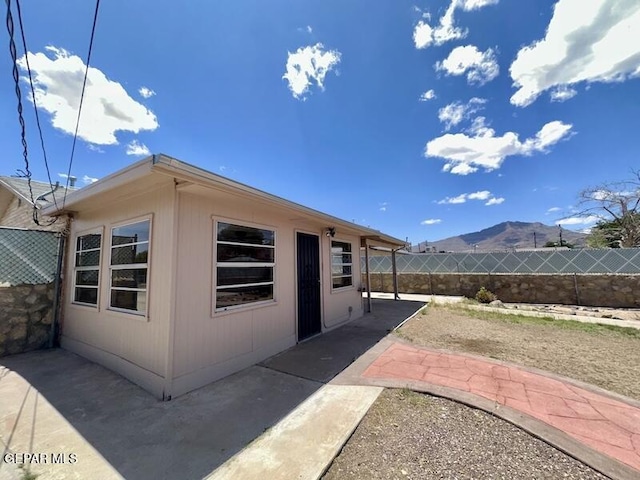 5017 Sierra Madre Dr, El Paso, TX 79904 - view of side of property featuring a mountain view, fence, and a patio area