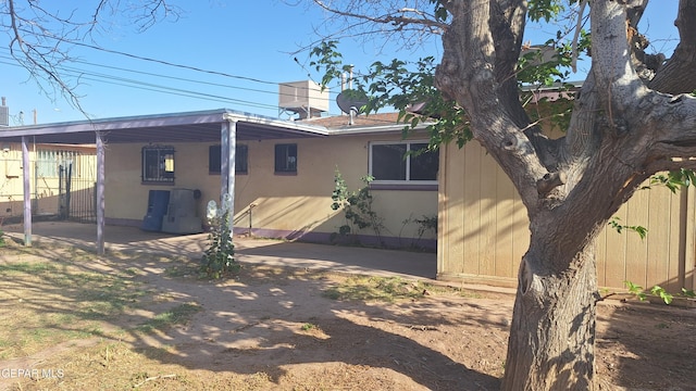 223 Kelvin Ave, El Paso, TX 79915 - back of house with an attached carport, fence, and stucco siding