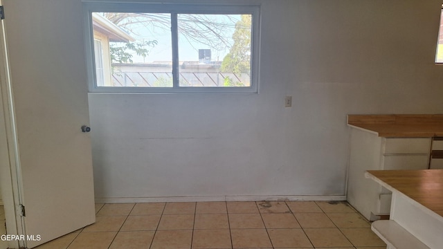 223 Kelvin Ave, El Paso, TX 79915 - unfurnished dining area with baseboards and light tile patterned flooring