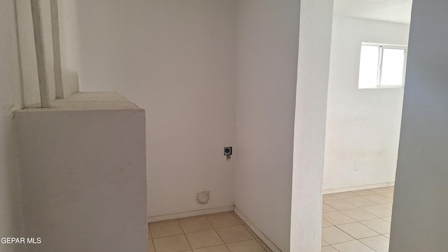223 Kelvin Ave, El Paso, TX 79915 - laundry room with electric dryer hookup, light tile patterned flooring, and baseboards