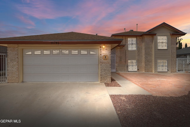 10740 White Sands Dr, El Paso, TX 79924 - view of front of house with concrete driveway, an attached garage, brick siding, and stone siding