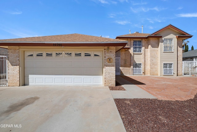 10740 White Sands Dr, El Paso, TX 79924 - view of front of property with driveway, stone siding, brick siding, and roof with shingles