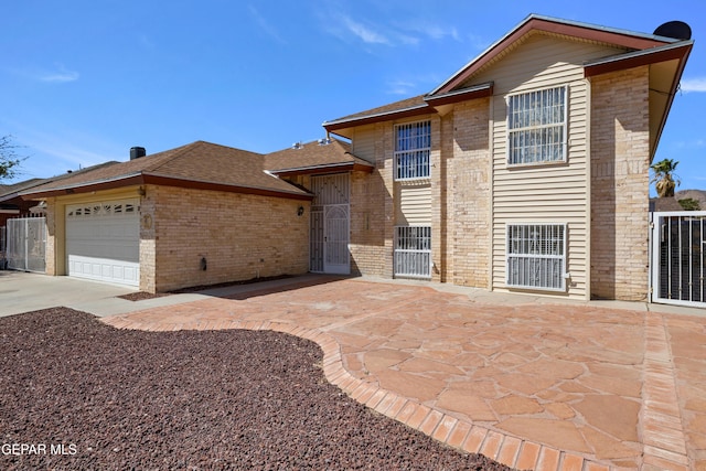 10740 White Sands Dr, El Paso, TX 79924 - view of front of property featuring brick siding, a garage, concrete driveway, and a shingled roof