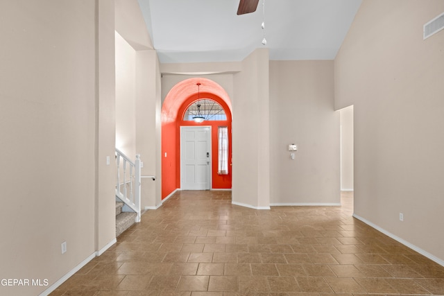 10740 White Sands Dr, El Paso, TX 79924 - entrance foyer with a ceiling fan, stairway, baseboards, and a towering ceiling