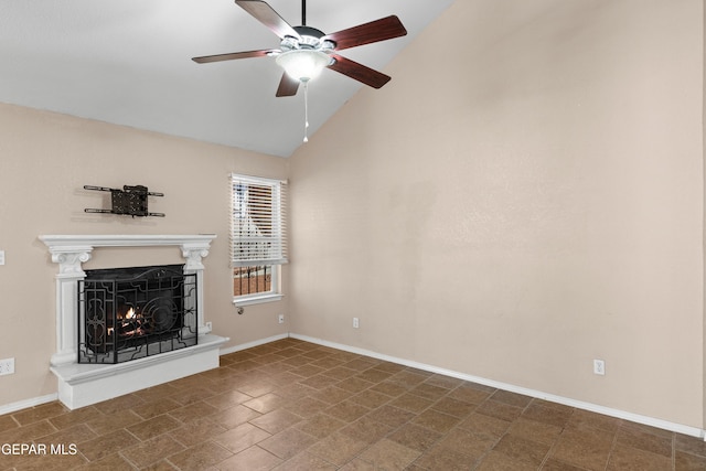 10740 White Sands Dr, El Paso, TX 79924 - unfurnished living room featuring a ceiling fan, a premium fireplace, baseboards, and high vaulted ceiling