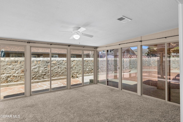 10740 White Sands Dr, El Paso, TX 79924 - unfurnished sunroom with carpet floors, a ceiling fan, and a textured ceiling