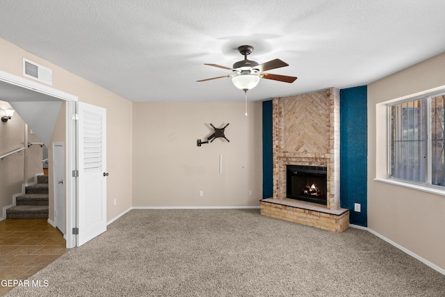 10740 White Sands Dr, El Paso, TX 79924 - unfurnished living room with ceiling fan, carpet, a brick fireplace, stairway, and baseboards