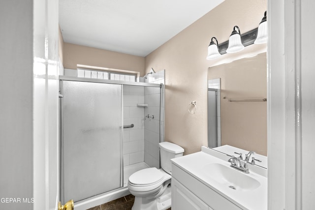 10740 White Sands Dr, El Paso, TX 79924 - full bathroom with a shower stall, toilet, vanity, a textured wall, and tile patterned floors
