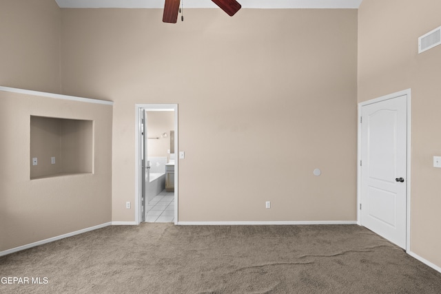 10740 White Sands Dr, El Paso, TX 79924 - carpeted spare room with a high ceiling, a ceiling fan, and baseboards