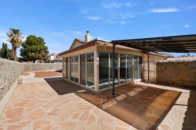 10740 White Sands Dr, El Paso, TX 79924 - fenced backyard featuring a sunroom and a patio area