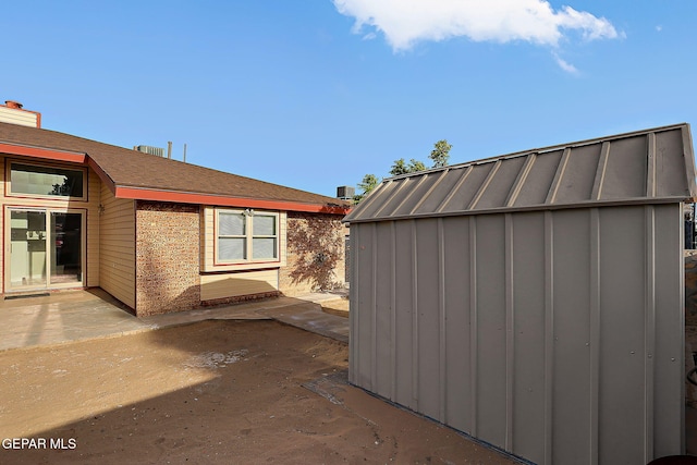 819 Los Surcos Rd, El Paso, TX 79907 - view of property exterior with a patio and board and batten siding