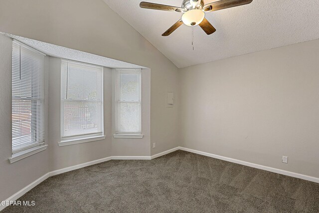 819 Los Surcos Rd, El Paso, TX 79907 - empty room featuring dark carpet, vaulted ceiling, a textured ceiling, ceiling fan, and baseboards