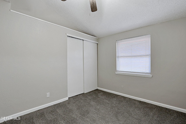 819 Los Surcos Rd, El Paso, TX 79907 - unfurnished bedroom with dark colored carpet, a closet, a textured ceiling, ceiling fan, and baseboards