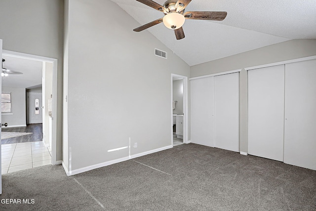 819 Los Surcos Rd, El Paso, TX 79907 - unfurnished bedroom with multiple closets, vaulted ceiling, carpet, ensuite bath, and ceiling fan