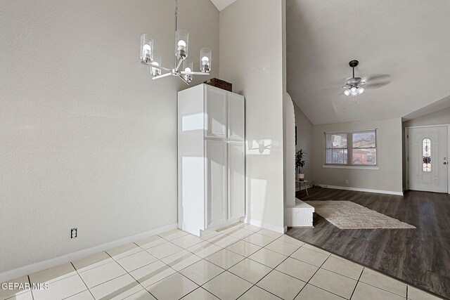 819 Los Surcos Rd, El Paso, TX 79907 - entryway with vaulted ceiling, baseboards, a chandelier, ceiling fan, and light tile patterned floors