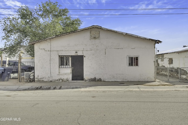 720 Johnson St, Fabens, TX 79838 - view of home's exterior featuring stucco siding and fence