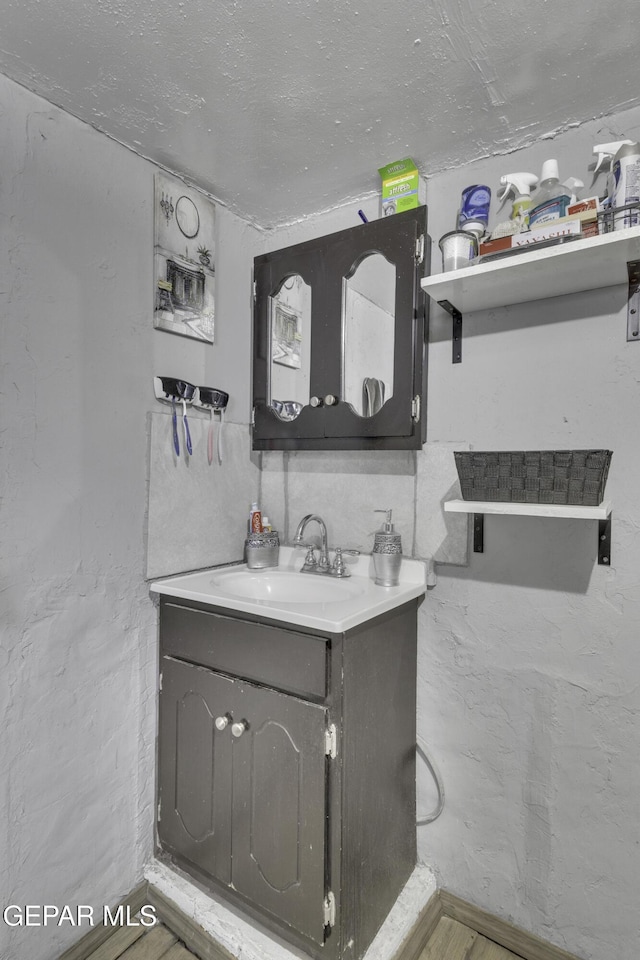 720 Johnson St, Fabens, TX 79838 - bathroom with vanity and wood finished floors