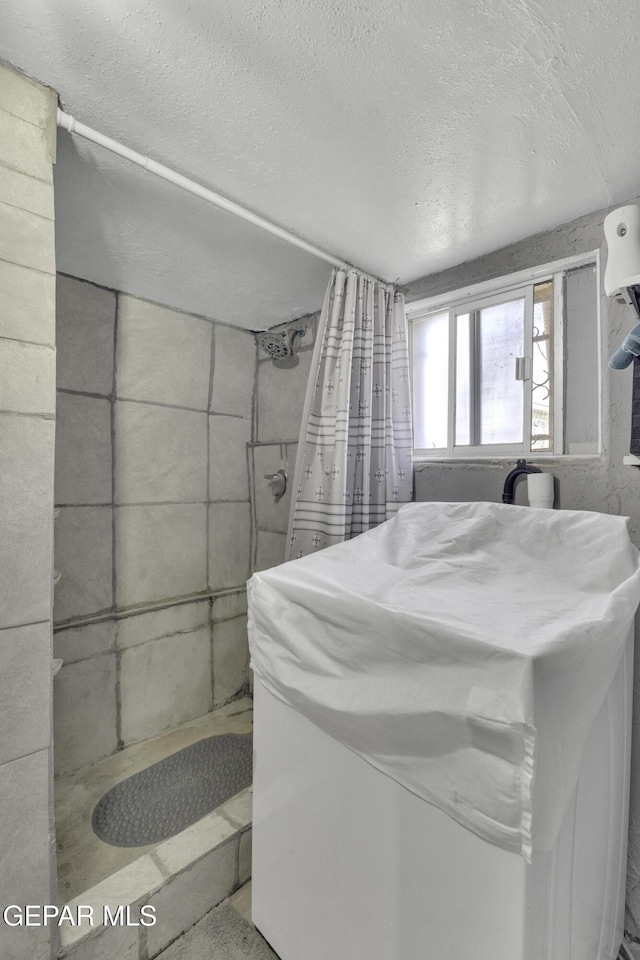 720 Johnson St, Fabens, TX 79838 - full bathroom with a shower stall and a textured ceiling