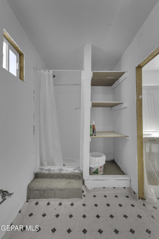 720 Johnson St, Fabens, TX 79838 - bathroom with a stall shower and tile patterned floors