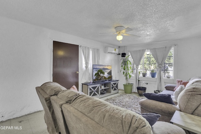 720 Johnson St, Fabens, TX 79838 - living area featuring a wall unit AC, a textured ceiling, a ceiling fan, and tile patterned floors