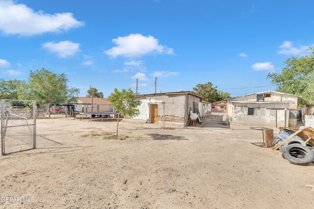 720 Johnson St, Fabens, TX 79838 - view of front facade with a trampoline, a gate, and fence