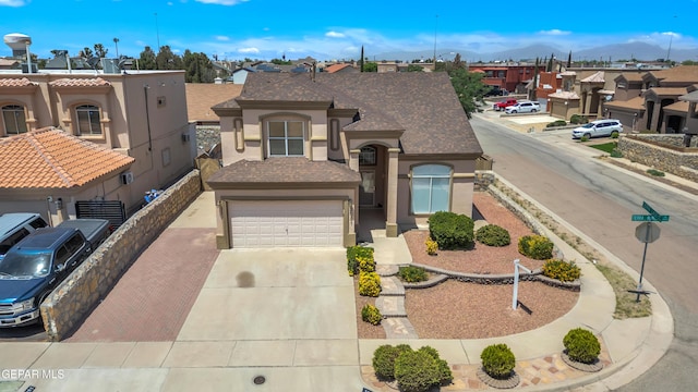 3081 Tierra Humeda Dr, El Paso, TX 79938 - view of front of house with a residential view, stucco siding, concrete driveway, a mountain view, and roof with shingles