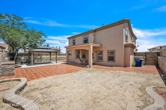 3081 Tierra Humeda Dr, El Paso, TX 79938 - back of house with a gazebo, a patio area, a fenced backyard, and stucco siding