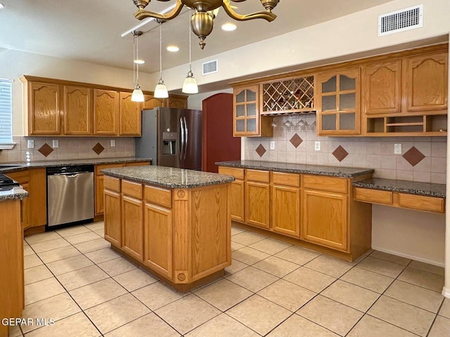3081 Tierra Humeda Dr, El Paso, TX 79938 - kitchen featuring appliances with stainless steel finishes, decorative backsplash, arched walkways, light tile patterned floors, and recessed lighting