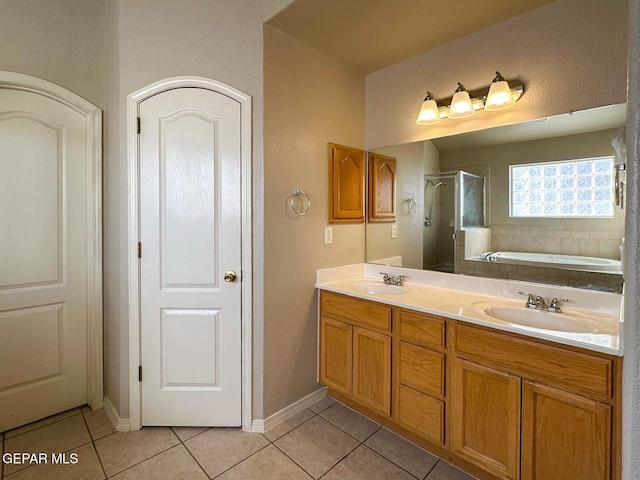 3081 Tierra Humeda Dr, El Paso, TX 79938 - full bath featuring tile patterned floors, a shower stall, a bath, double vanity, and baseboards