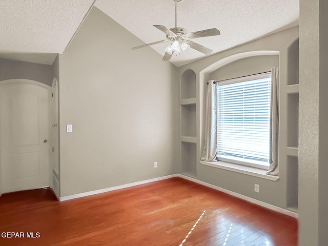 3081 Tierra Humeda Dr, El Paso, TX 79938 - spare room with a textured ceiling, wood finished floors, arched walkways, baseboards, and ceiling fan