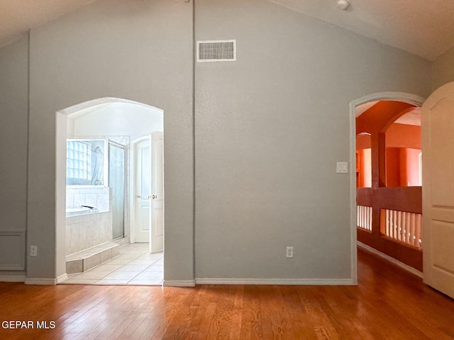3081 Tierra Humeda Dr, El Paso, TX 79938 - unfurnished bedroom with vaulted ceiling, wood finished floors, baseboards, and arched walkways
