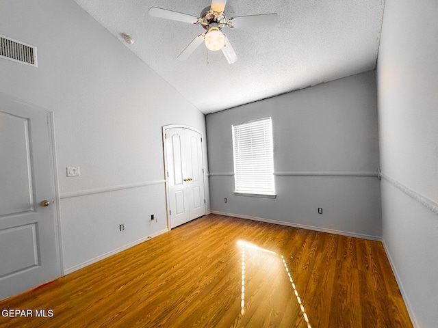3081 Tierra Humeda Dr, El Paso, TX 79938 - unfurnished room with wood finished floors, vaulted ceiling, a textured ceiling, ceiling fan, and baseboards