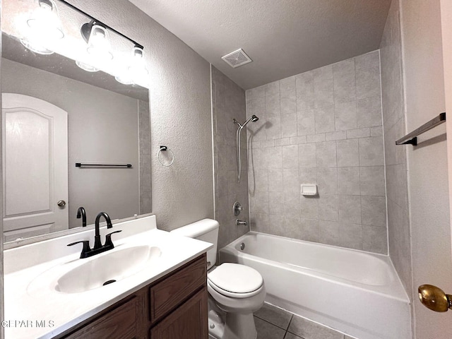 3081 Tierra Humeda Dr, El Paso, TX 79938 - full bath with a textured wall, tile patterned floors, vanity, toilet, and shower / bathtub combination