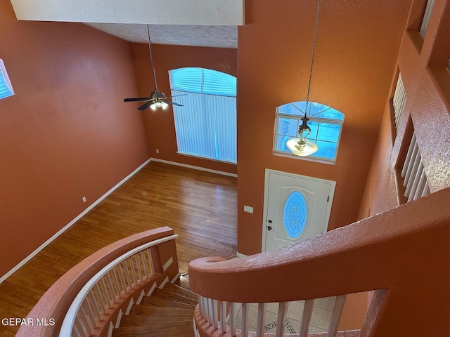3081 Tierra Humeda Dr, El Paso, TX 79938 - entryway with wood finished floors, baseboards, a ceiling fan, and a towering ceiling