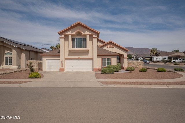 7350 Rosas Way, Canutillo, TX 79835 - view of front of home featuring stucco siding, driveway, an attached garage, and a mountain view