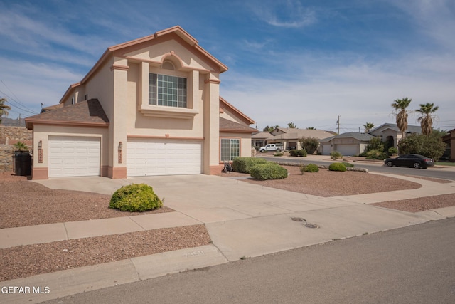 7350 Rosas Way, Canutillo, TX 79835 - view of front facade with stucco siding, driveway, and a garage