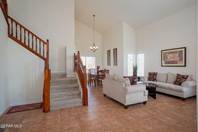 7350 Rosas Way, Canutillo, TX 79835 - living area with a chandelier, stairs, high vaulted ceiling, light tile patterned floors, and baseboards