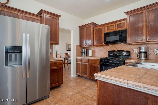 7350 Rosas Way, Canutillo, TX 79835 - kitchen featuring black appliances, tasteful backsplash, a sink, and light countertops