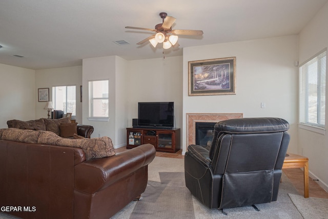 7350 Rosas Way, Canutillo, TX 79835 - living area with ceiling fan, a glass covered fireplace, carpet flooring, and baseboards