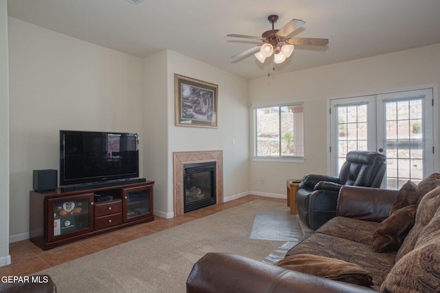 7350 Rosas Way, Canutillo, TX 79835 - tiled living area with a glass covered fireplace, a ceiling fan, baseboards, and french doors