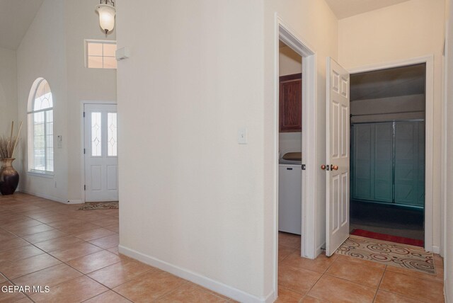 7350 Rosas Way, Canutillo, TX 79835 - entrance foyer with light tile patterned floors, baseboards, and washer / clothes dryer