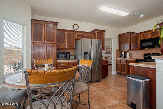 7350 Rosas Way, Canutillo, TX 79835 - kitchen featuring black appliances, light countertops, backsplash, and light tile patterned floors