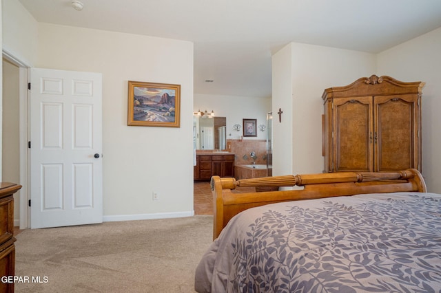 7350 Rosas Way, Canutillo, TX 79835 - bedroom featuring light carpet, connected bathroom, and baseboards